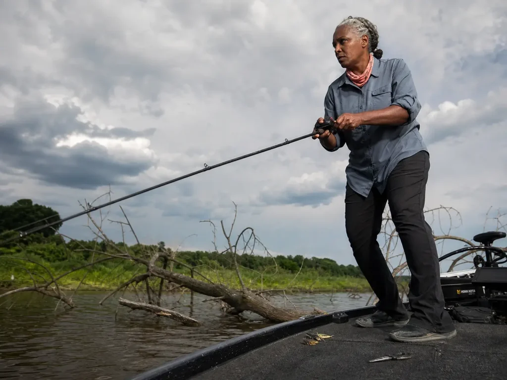Angler working a jig on a Shimano Zodias graphite casting rod along flooded timber